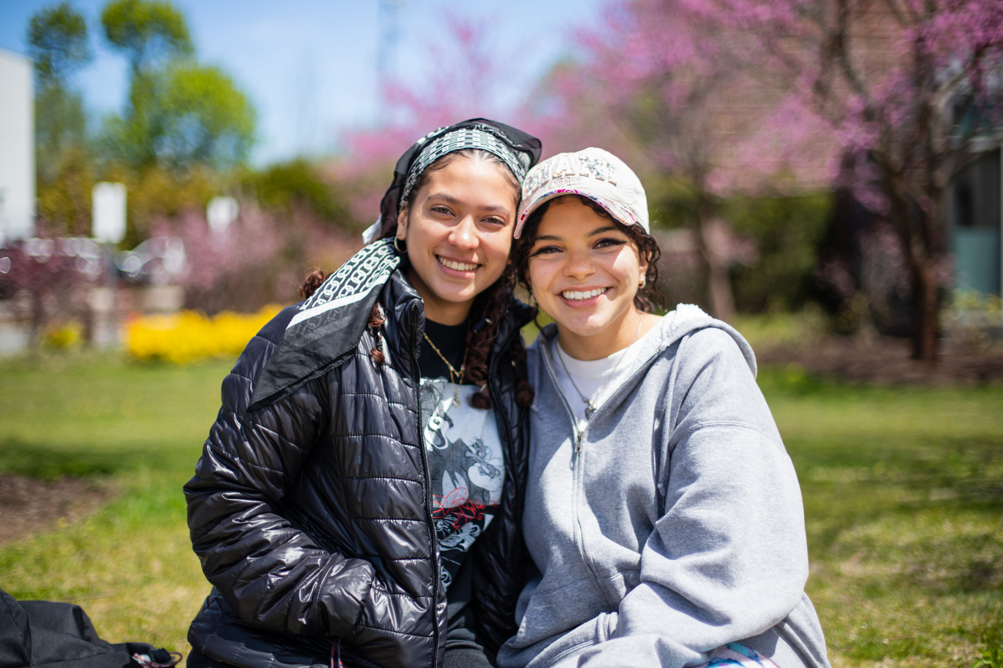 Two smiling students outside on Harrington campus