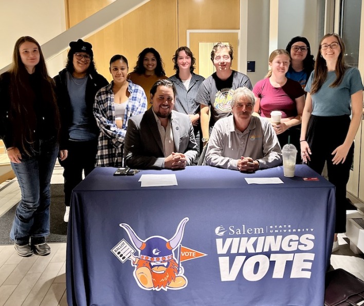 City Councilors and students around a Vikings Vote table