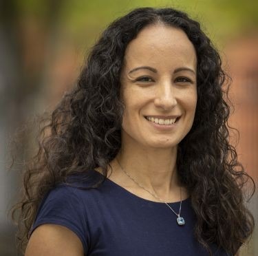 Headshot of alumna Nancy Dias, seen wearing a blue top.