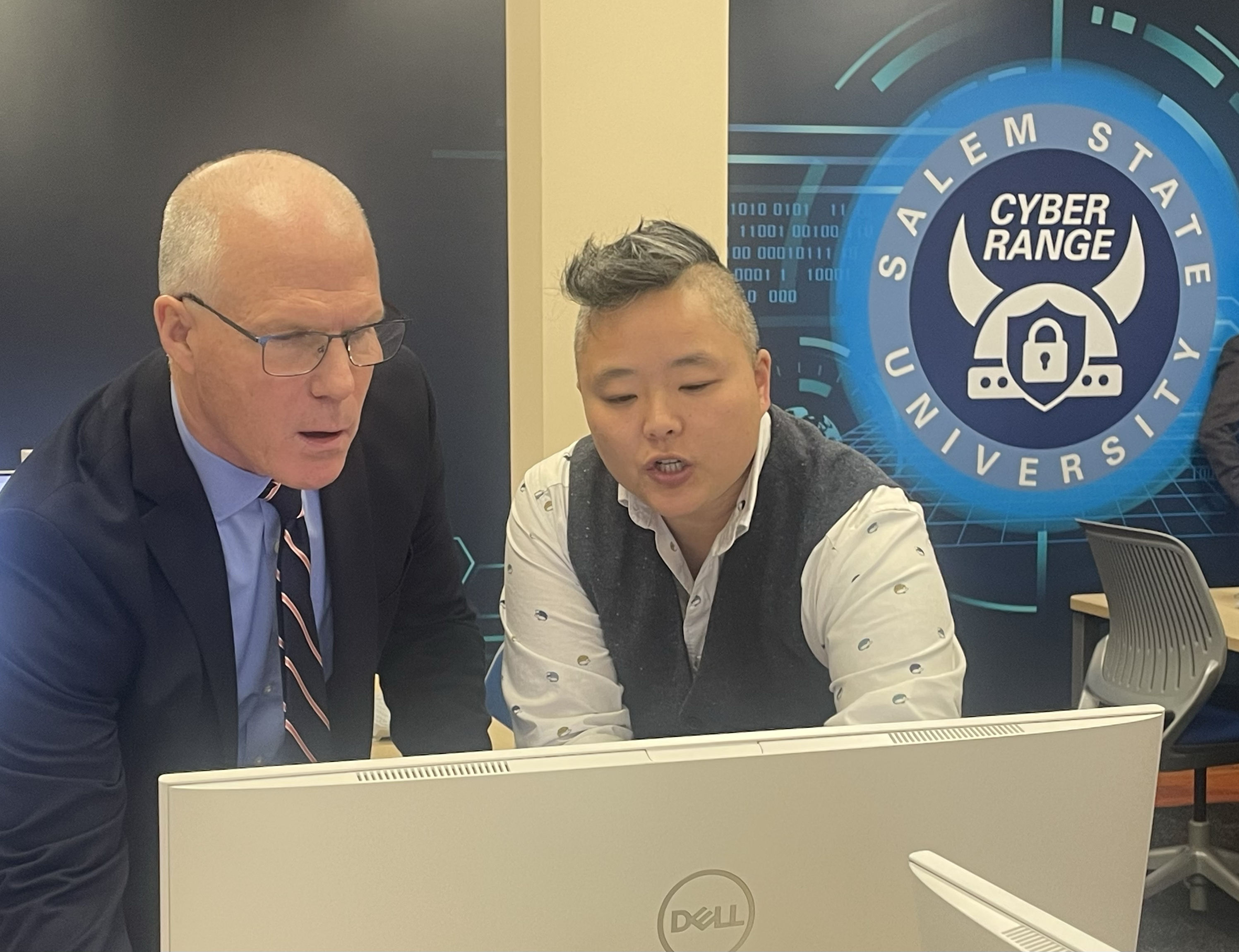 President Keenan and the Cyber Range Staff at a workstation