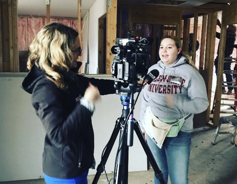 Gabriella Cullenburg talks to a television reporter during a Habitat for Humanity trip.