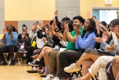 Photo from the CJL ALANA Graduation Ceremony 2024. Students seated, cheering an…