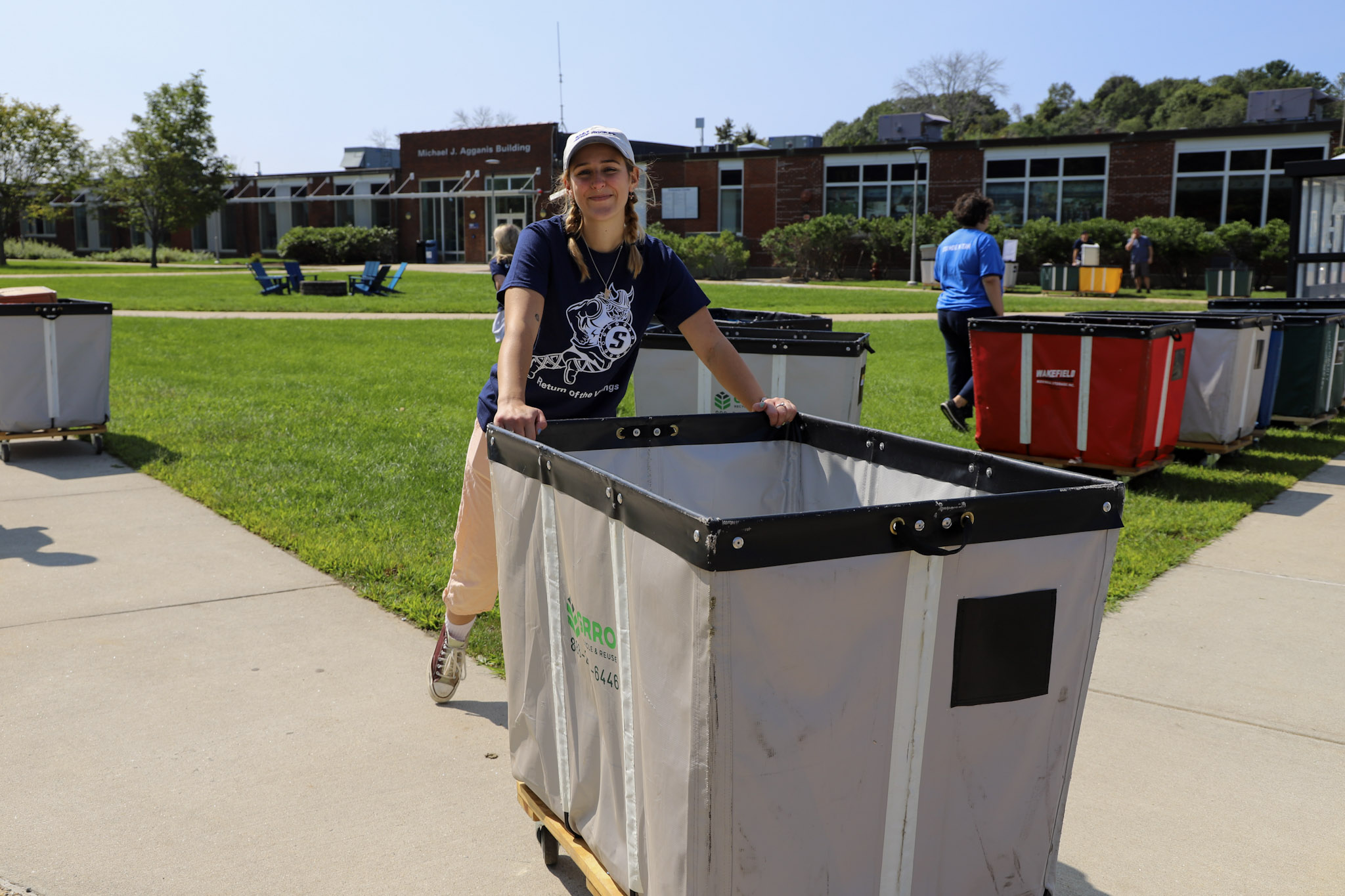 A student leader with a moving cart full of furnishings