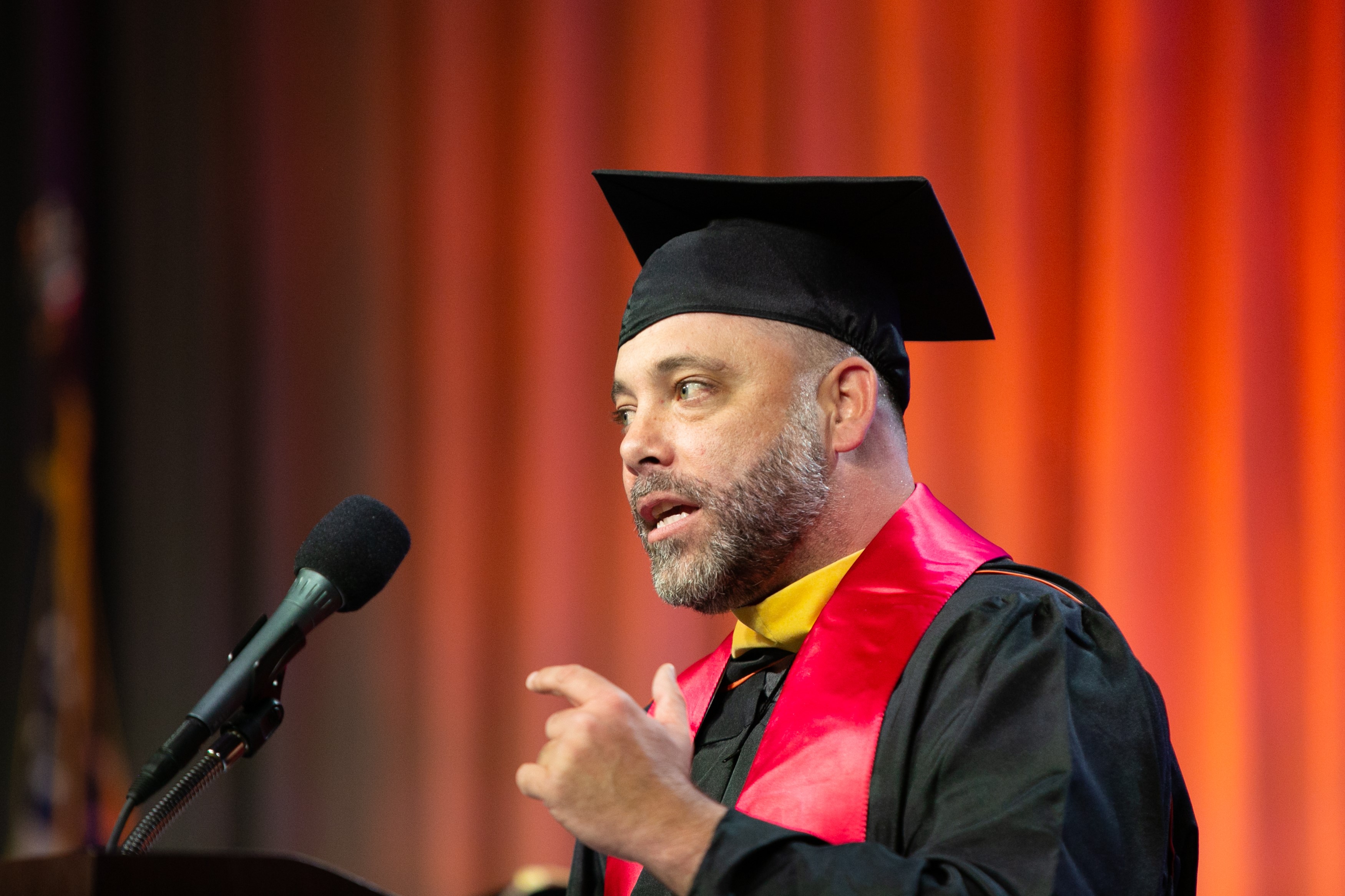 Joseph Tocci at the podium speaking during commencement