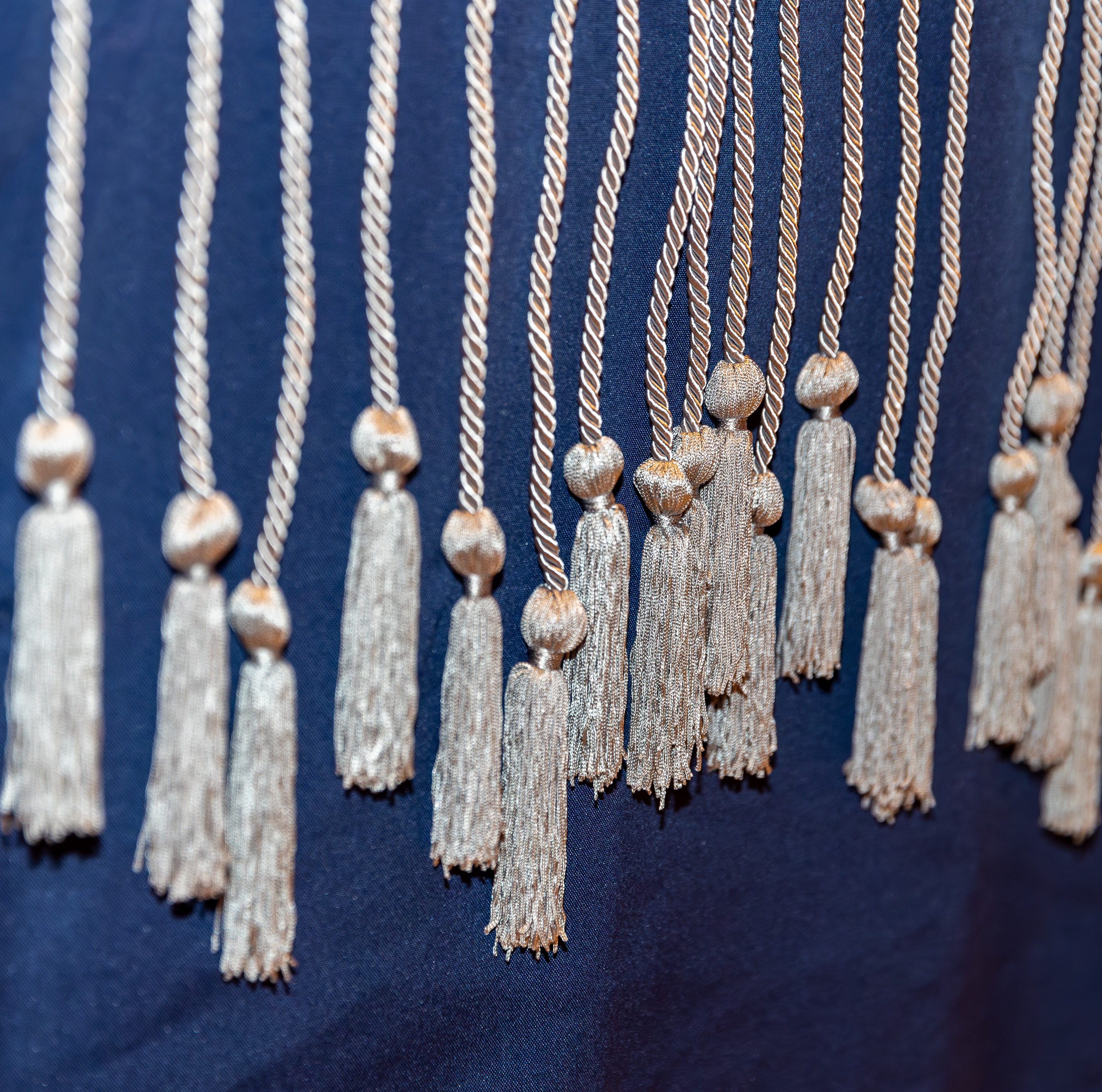 Image of silver cords hanging over a blue tablecloth