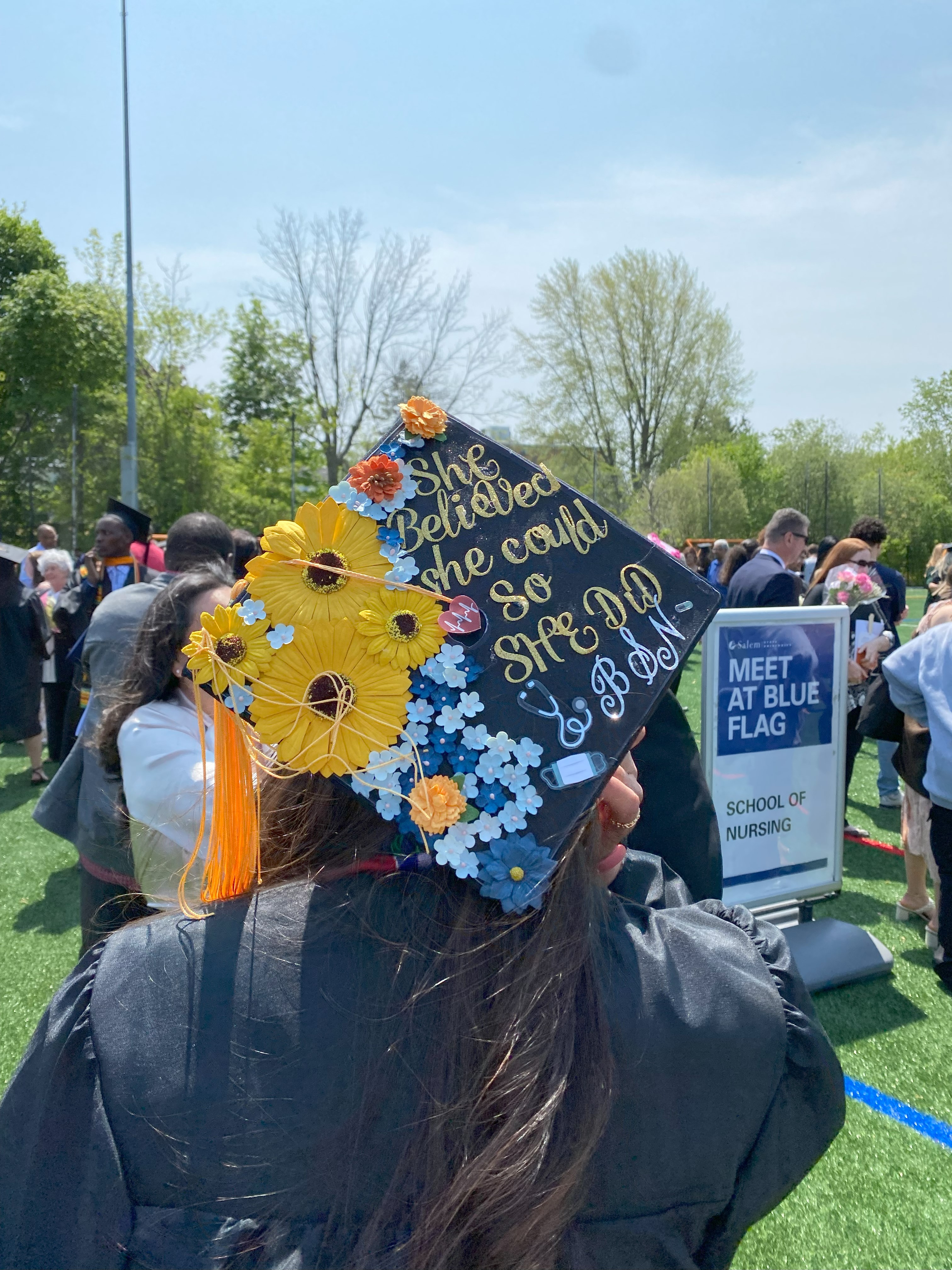 Graduation cap decorated with flowers that reads 'She believed she could so she did' BSN