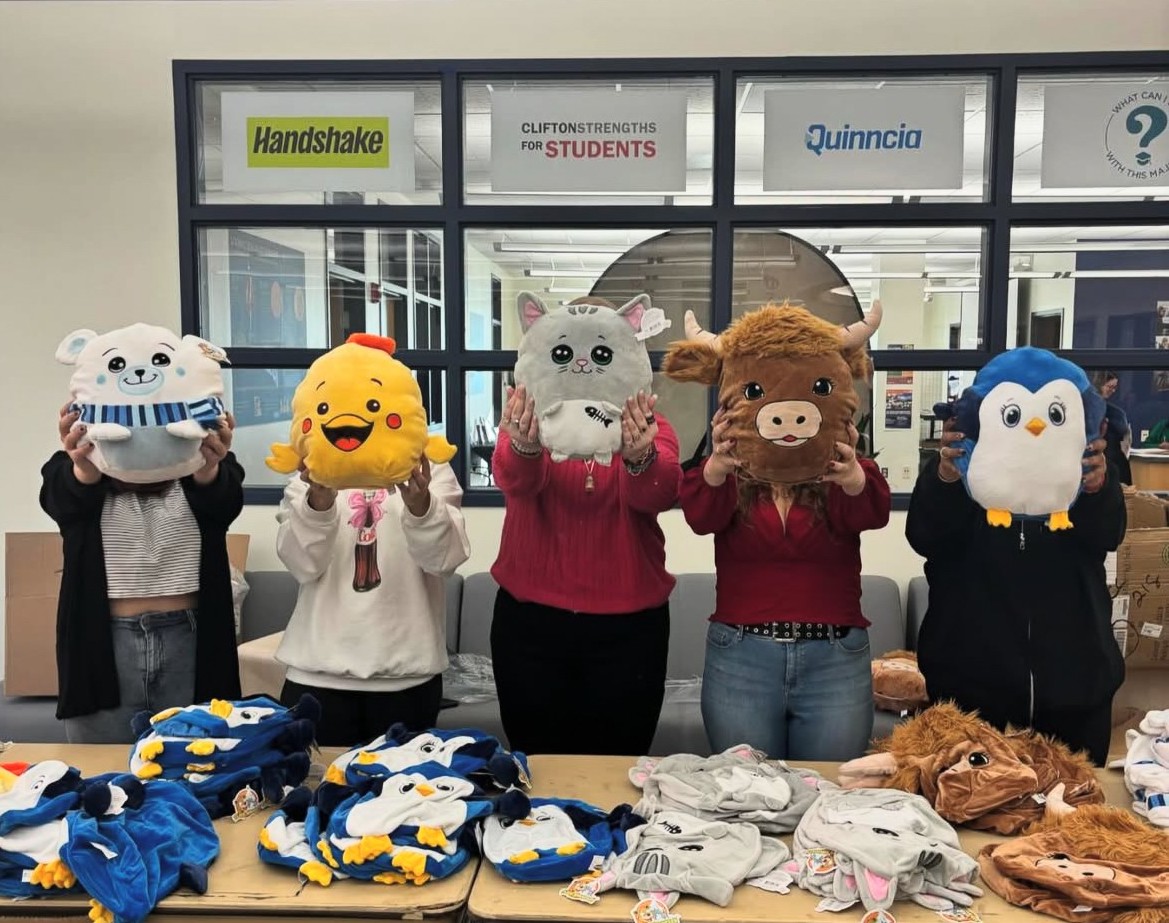 Program Council members holding their stuff a plush items