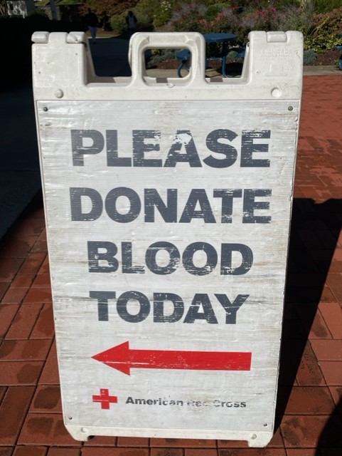 Red Cross Sign asking people to "Please donate blood today"