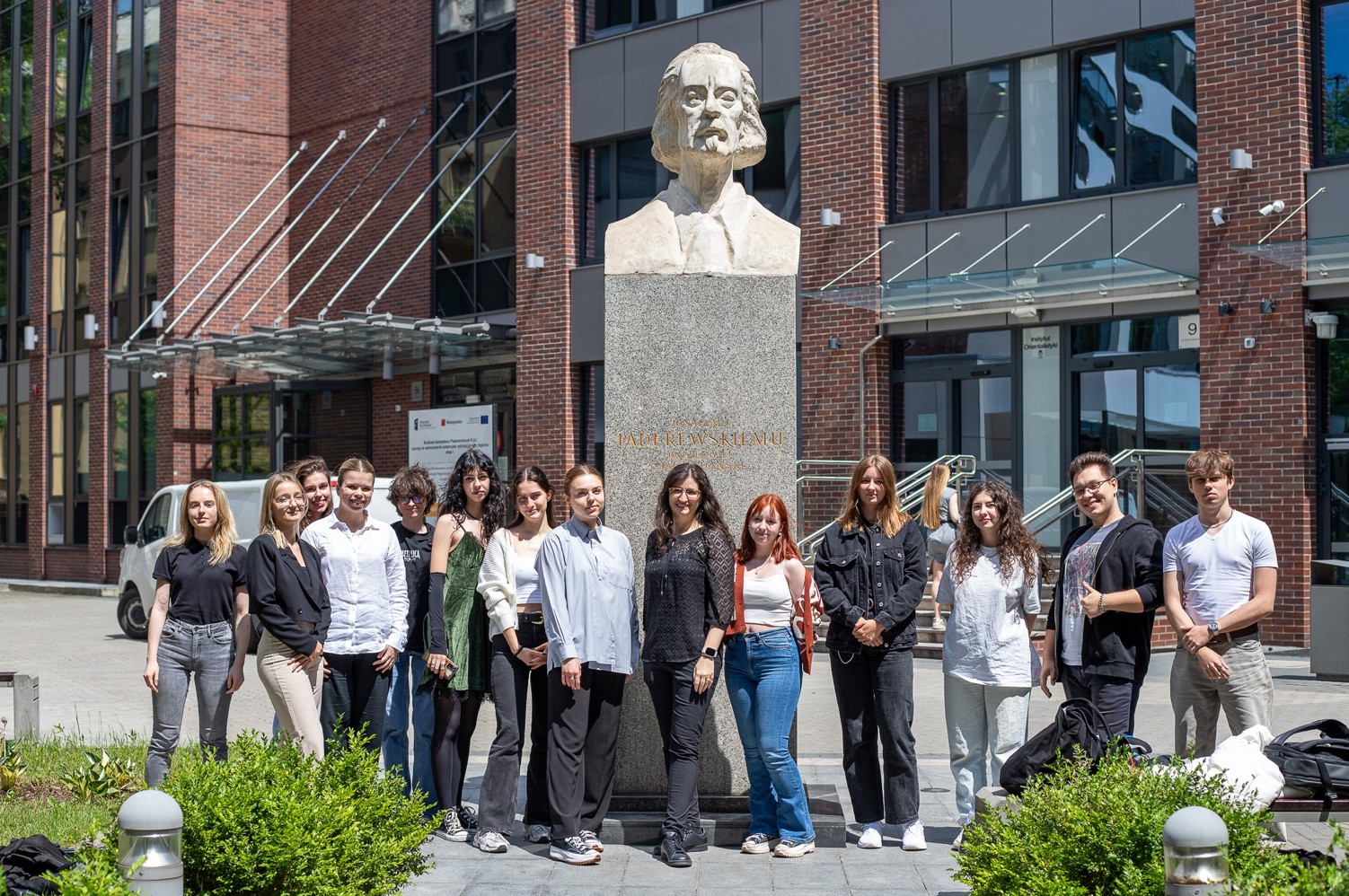 Rebecca Hains and her students at the Institute of English Studies, Jagiellonian University, Krakow, Poland, June 4, 2024, on the occasion of their last class meeting. They are in the courtyard of the Jagiellonian’s Collegium Paderevianum, by a monum