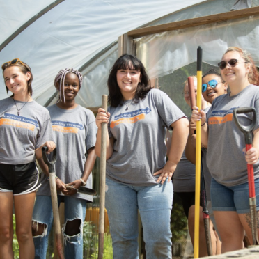 Group of students volunteering on a farm