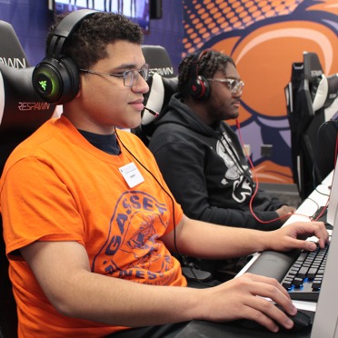 A Salem State student playing in the eSports lounge