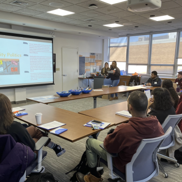 Students at the Running for Office session sit in a classroom and look at a projector screen.