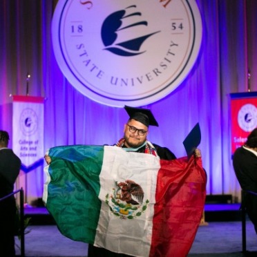 Student with Mexican flag at commencement