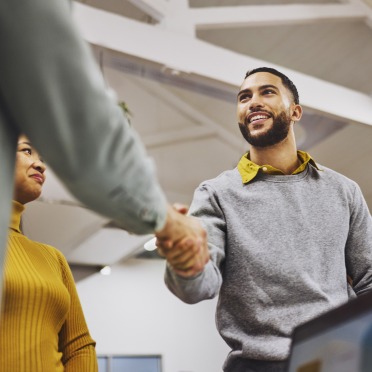 A young person shaking someone's hand