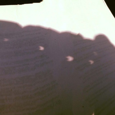 A reflection of the moon appears on a textbook. 