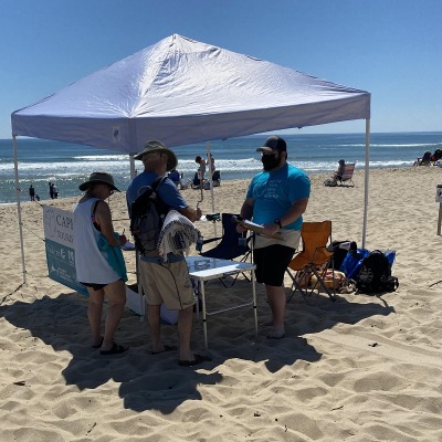 People on the beach under a canopy