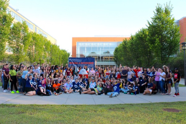 Salem State students participating in day of service posing for a group photo on the quad