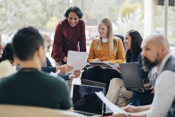 A group of teachers gathered in a circle talking