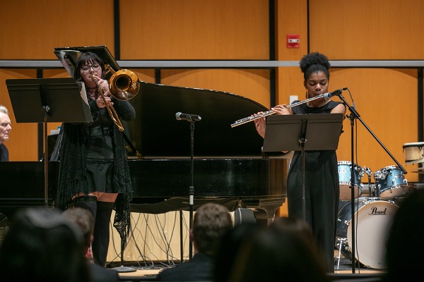 Two instrumentalists in the improv ensemble onstage