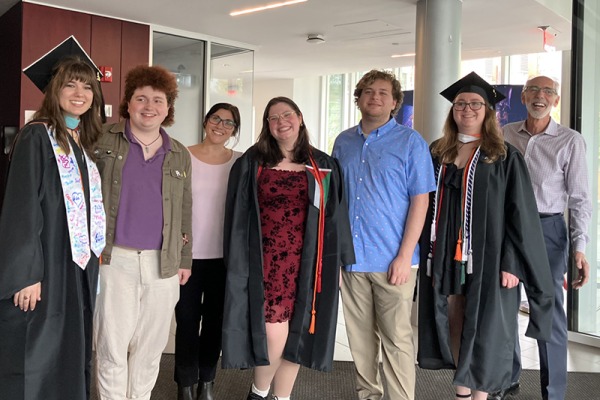 A group of graduating students and faculty together