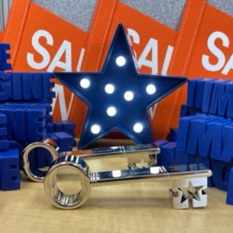 Image of silver keys with blue light up star and Salem State pennants behind them, with 3-D words "imagine" piled up on either side