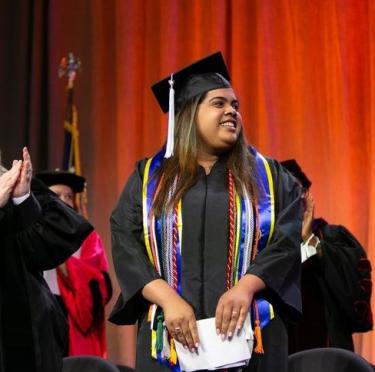 Anngerline Burgos on the stage at Commencement